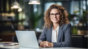 Businesswoman in glasses using laptop.