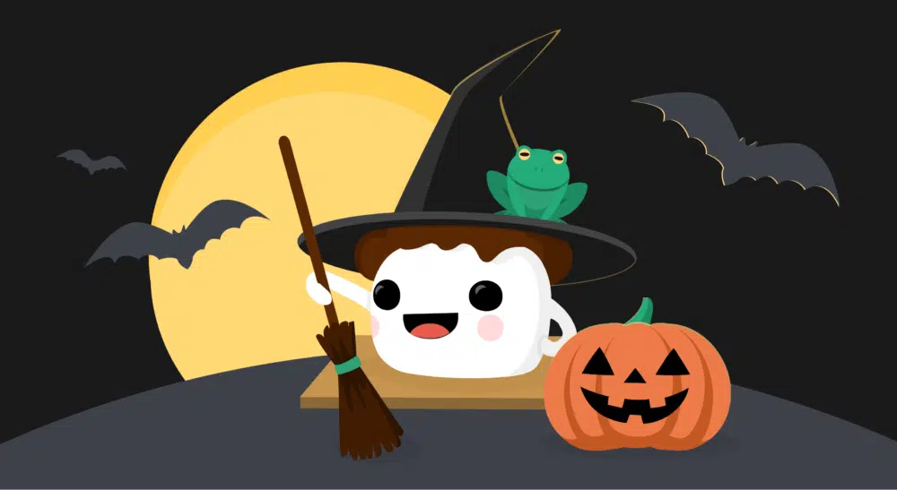 Smore mascot dressed as a witch with a full moon, bats, green frog, and pumpkin.