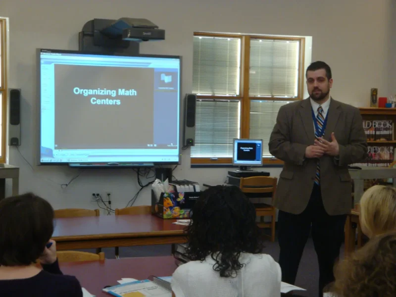 Teacher giving a presentation called Organizing Math Centers.